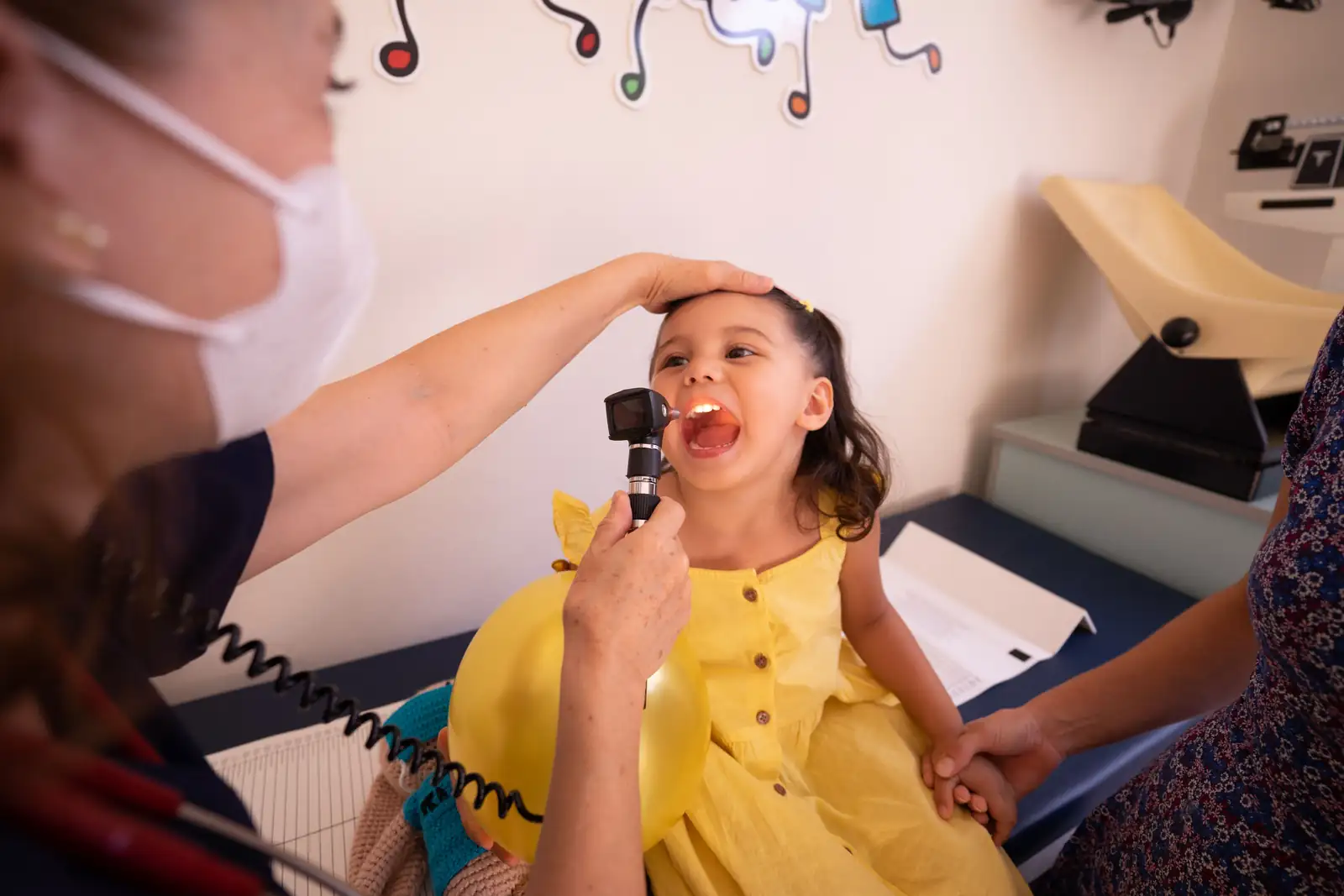 Pediatrician consulting a mother and child in a clinic office