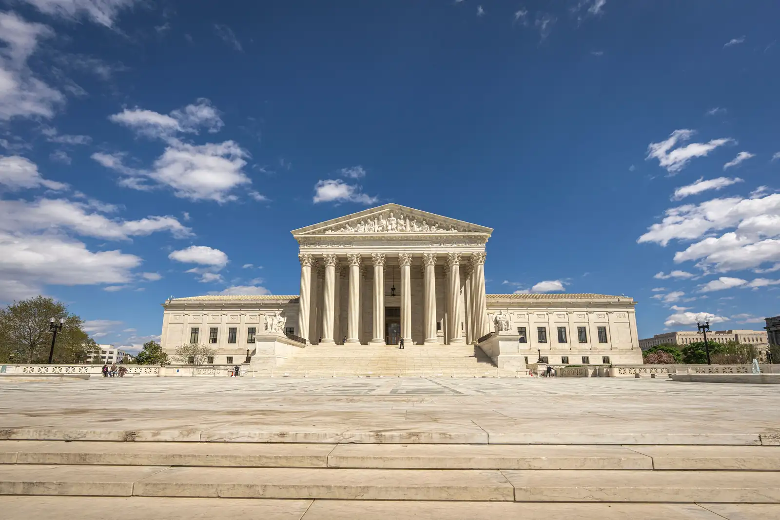 The US Supreme Court building in Washington, DC, under a blue sky