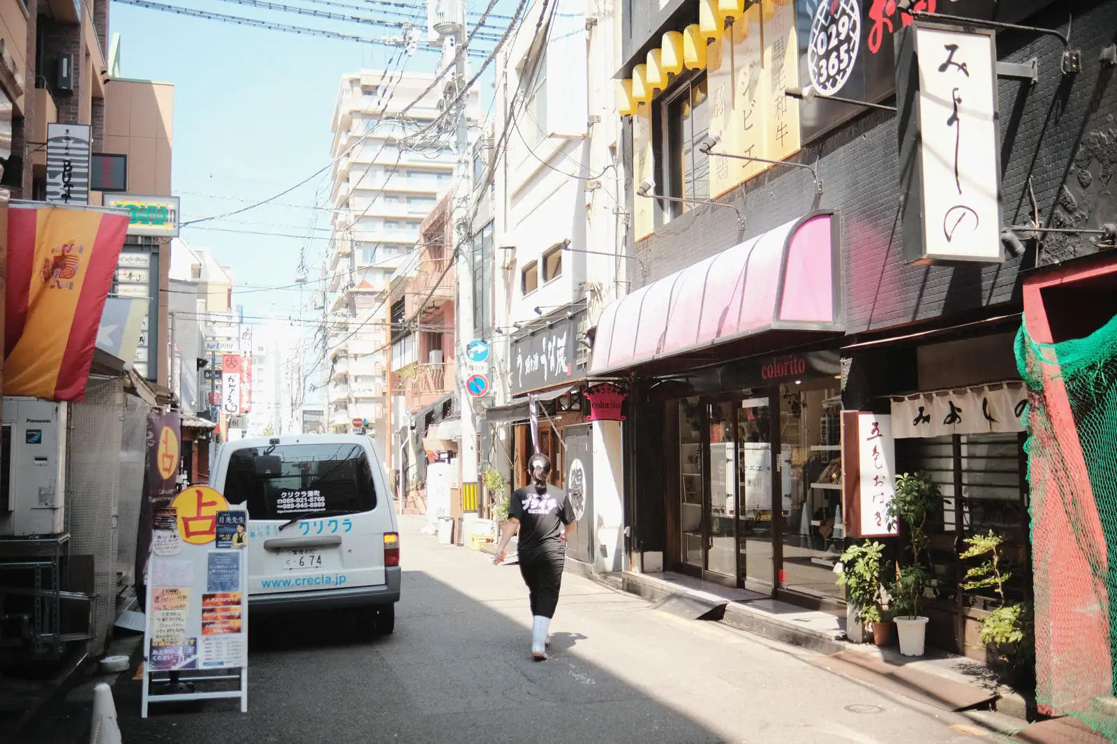 A street lined with small shops and restaurants in Japan