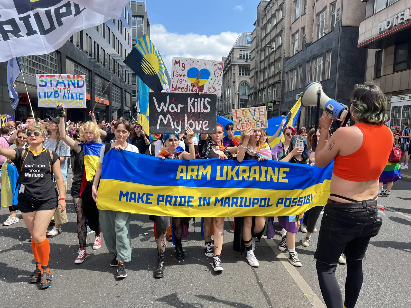 Parade of people holding flags and placards